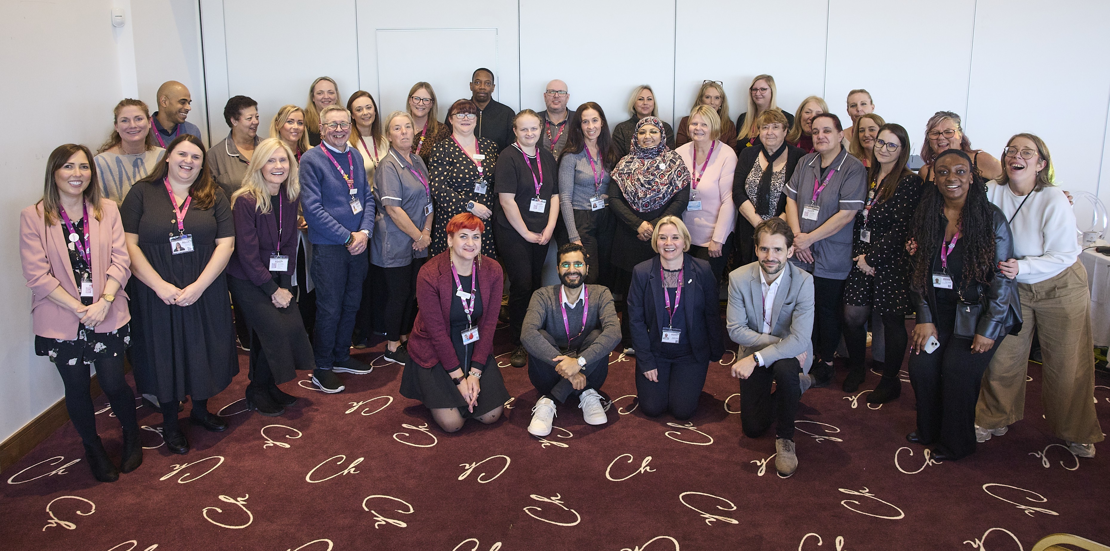 smiling people at a desk