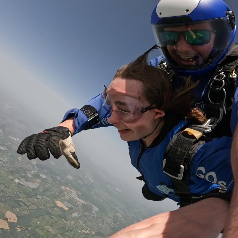 Lucy skydiving out of a plane